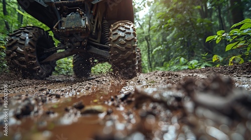An ATV's journey through a dense, muddy forest trail, wheels spinning, mud splattering, trees and foliage in the background