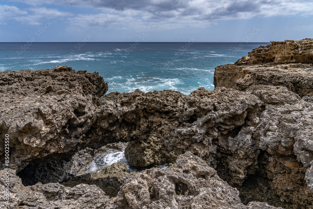 Coral reef and beachrocks,Beachrock is a friable to well-cemented sedimentary rock. Kaena point / Yokohama bay, Leeward Coast of Oahu, Hawaii. Coral reef and beachrocks,Beachrock is a friable to well-cemented sedimentary rock. Kaena point / Yokohama bay, Leeward Coast of Oahu, Hawaii.