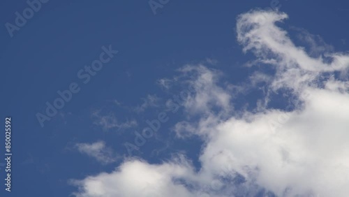 moving clouds in the blue sky
