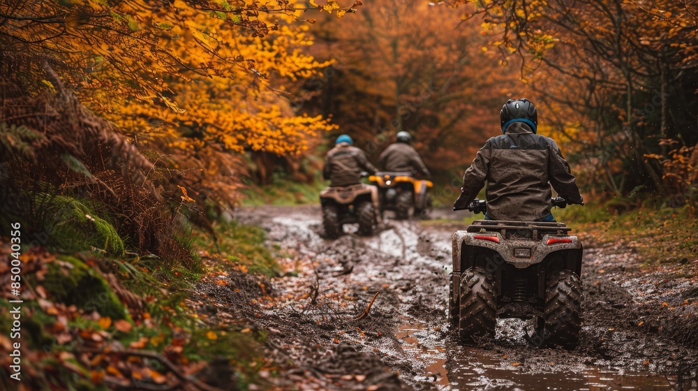 Dirty quad bikes on a rugged, muddy trail in an autumn woodland, with vibrant fall foliage adding contrast to the scene Dirty quad bikes on a rugged, muddy trail in an autumn woodland, with vibrant fall foliage adding contrast to the scene