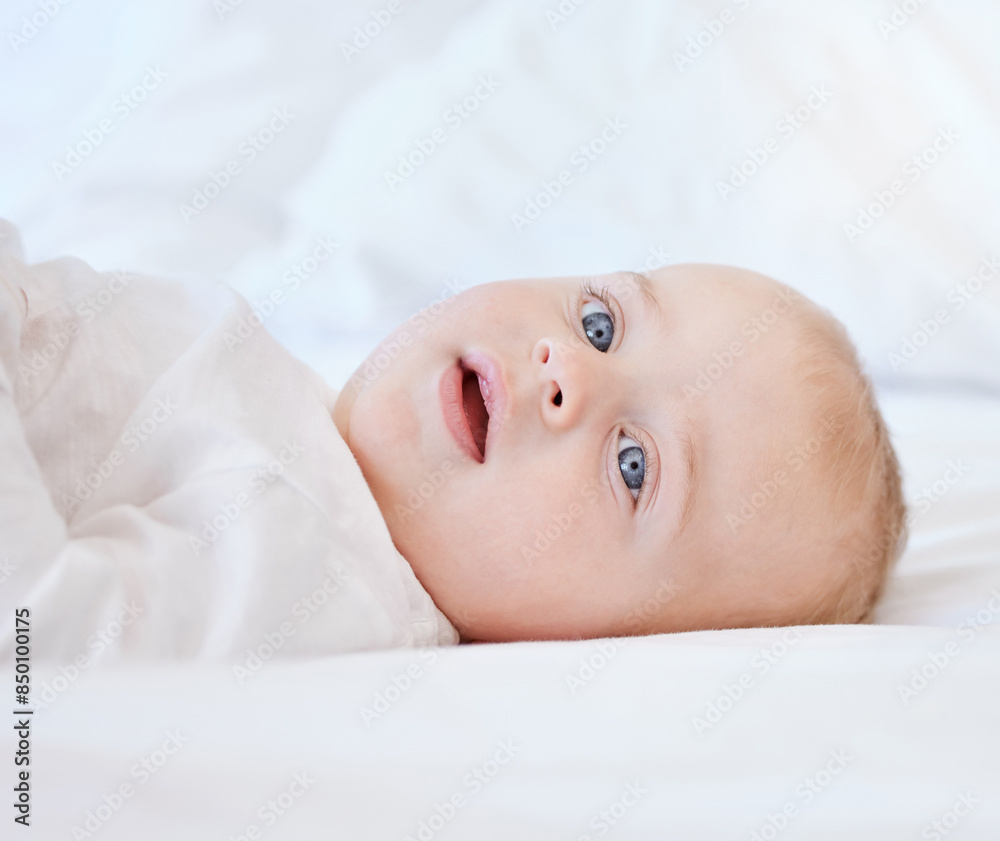 Relax, portrait and baby on a bed for morning, comfort and wake up with smile and development. Child, growth and happy face of boy or kid in a apartment or nursery for wellness and calm in home Relax, portrait and baby on a bed for morning, comfort and wake up with smile and development. Child, growth and happy face of boy or kid in a apartment or nursery for wellness and calm in home