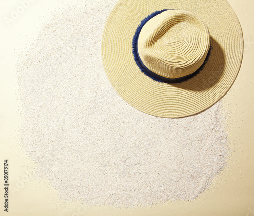 a cool straw hat against a sea sand background. top view. An empty space for display cosmetic products, food and props.