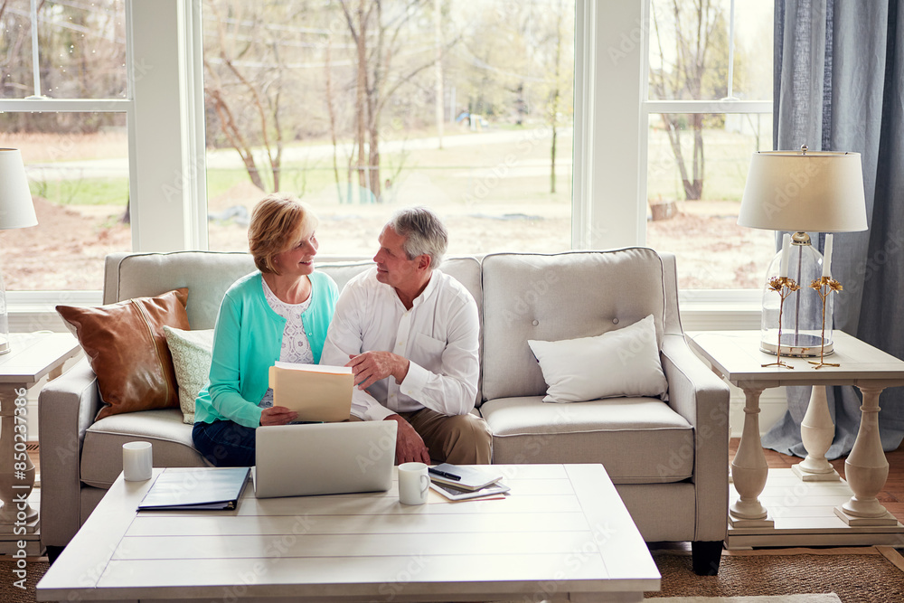 Documents, computer and mature couple on sofa with financial report, insurance and investment in home. Retirement, marriage and senior man and woman on laptop for finance, pension or internet banking
