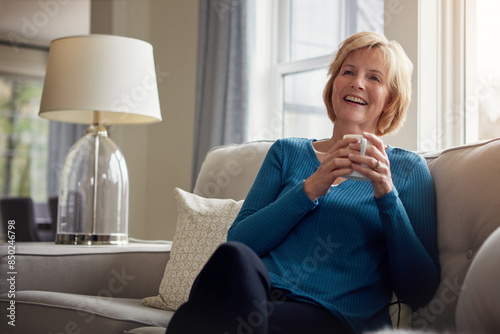 Obraz na plátně Happy, thinking and senior woman on sofa with coffee, relax and nostalgic morning reflection at home