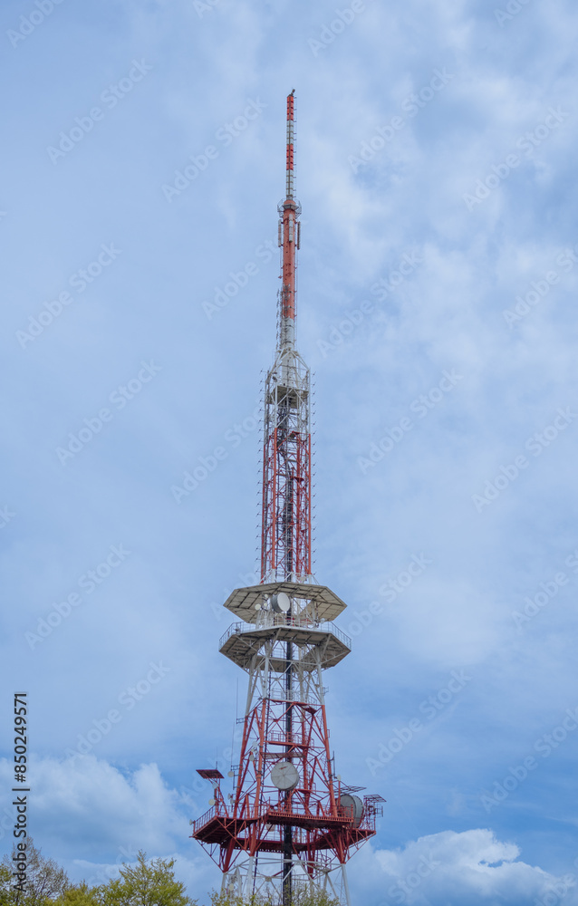 Telecommunications tower against cloudy sky Telecommunications tower against cloudy sky