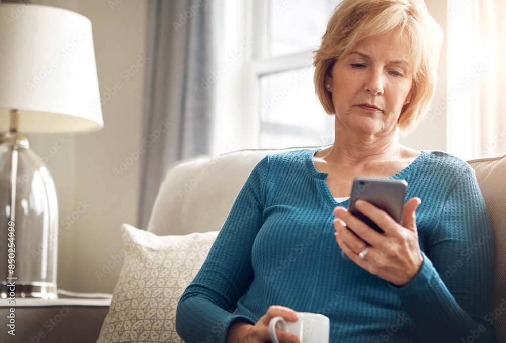 Home, serious and old woman on sofa with smartphone, typing and connection with social media in living room. Senior person, coffee and apartment with cellphone, internet and digital app with message Home, serious and old woman on sofa with smartphone, typing and connection with social media in living room. Senior person, coffee and apartment with cellphone, internet and digital app with message