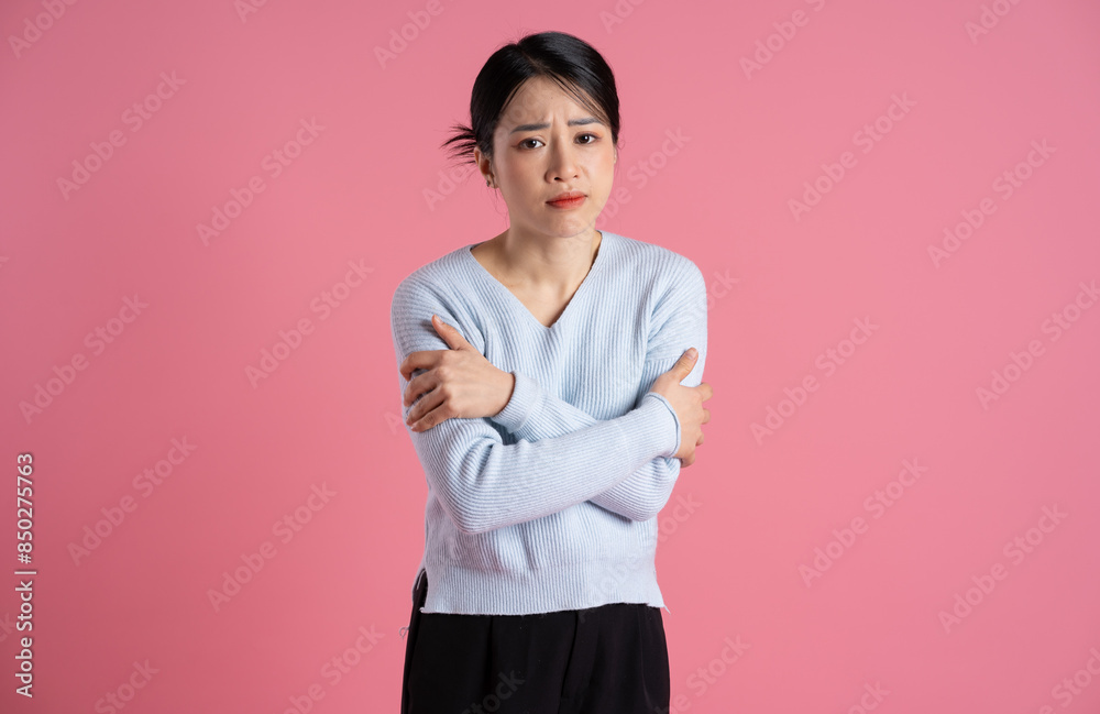 Portrait of beautiful asian woman posing on pink background Portrait of beautiful asian woman posing on pink background
