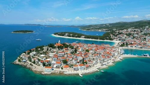 Experience the enchanting beauty of Primošten, a small island town on the Adriatic coast of Croatia, through this captivating drone footage.  photo
