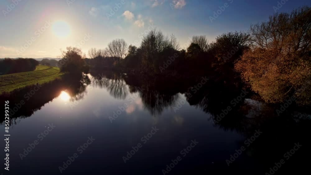 Drone Aerial drone cinematic clip of a winter sunset on a calm river. Drone Aerial drone cinematic clip of a winter sunset on a calm river.