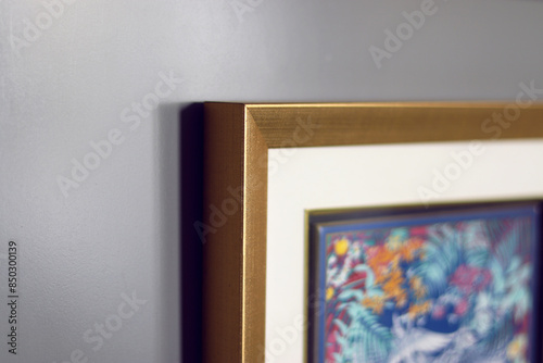 close up of golden photo frame made with wood on a grey background