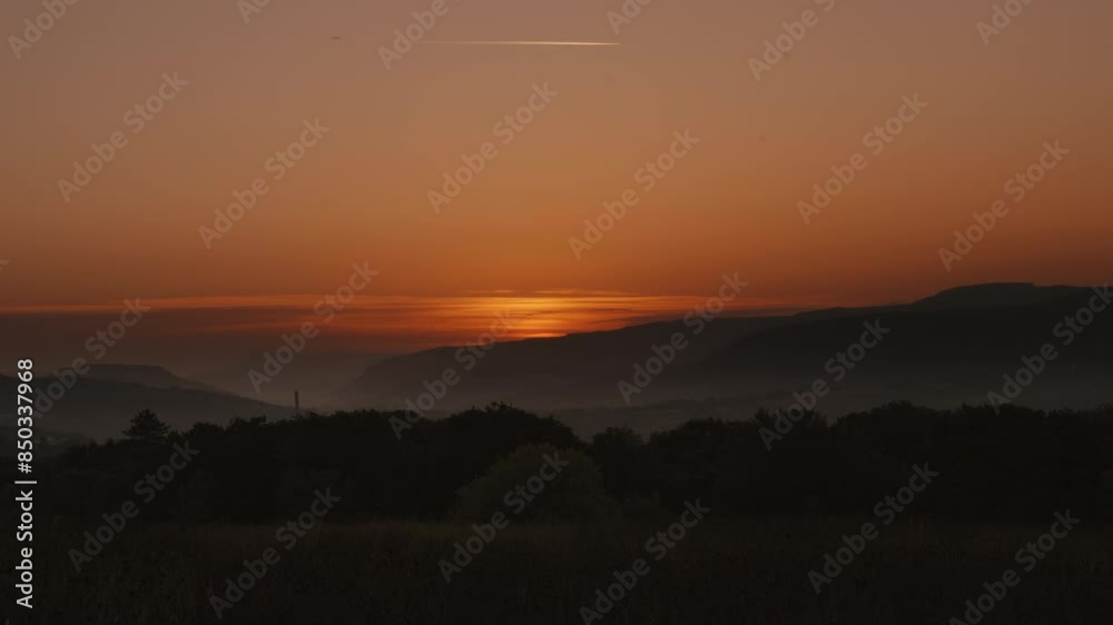 Timelapse of Sunrise On Horizon Over Welsh Valley Landscape with Mountain Background with Low Lying Fog and Trees Timelapse of Sunrise On Horizon Over Welsh Valley Landscape with Mountain Background with Low Lying Fog and Trees