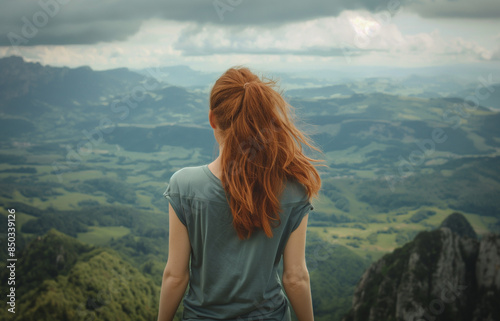 Vue de dos d'une Jeune femme en voyage qui regarde un magnifique panorama de montagne © Chlorophylle
