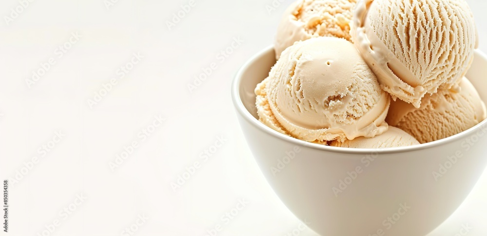 A white bowl contains some white ice cream on a white background A white bowl contains some white ice cream on a white background