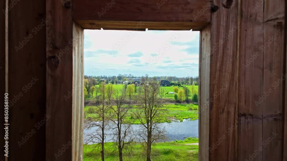 View of river,nature and tree landscape through wooden frame window View of river,nature and tree landscape through wooden frame window