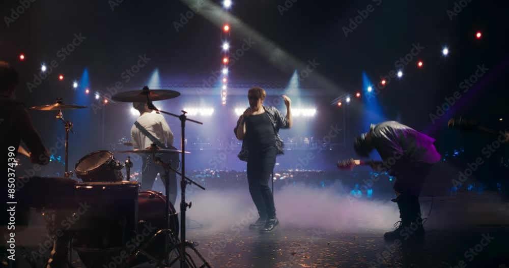 Rock Musicians in Fashionable Outfits Performing Alternative Punk Rock Music on a Nightclub Stage, Passionately Playing Guitars Under Bright Spotlights, Bringing Energy to Cheering Fans Rock Musicians in Fashionable Outfits Performing Alternative Punk Rock Music on a Nightclub Stage, Passionately Playing Guitars Under Bright Spotlights, Bringing Energy to Cheering Fans