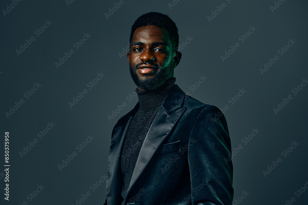 Elegant man in black suit and turtleneck exudes confidence against a dark background Elegant man in black suit and turtleneck exudes confidence against a dark background