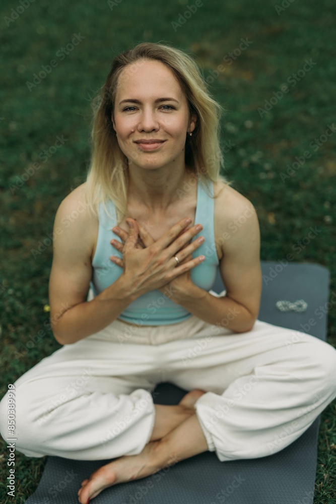 young woman athlete in sportswear practices yoga, enjoys training young woman athlete in sportswear practices yoga, enjoys training