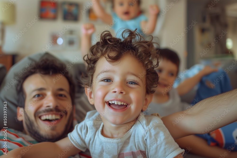 A father and his two sons are laughing together at home, enjoying a moment of pure joy A father and his two sons are laughing together at home, enjoying a moment of pure joy