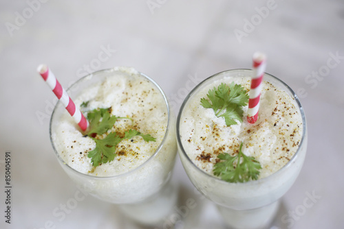 Chaas Masala Lassi with mint served in glass isolated on table top view of punjabi culture