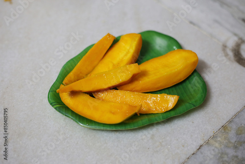 Isolated mango collection. Thai yellow mango fruits of different shapes, pieces and leaves isolated on marbel background Photo alphonso mango or hapoos aam is a seasonal and juicy fruit from india  photo