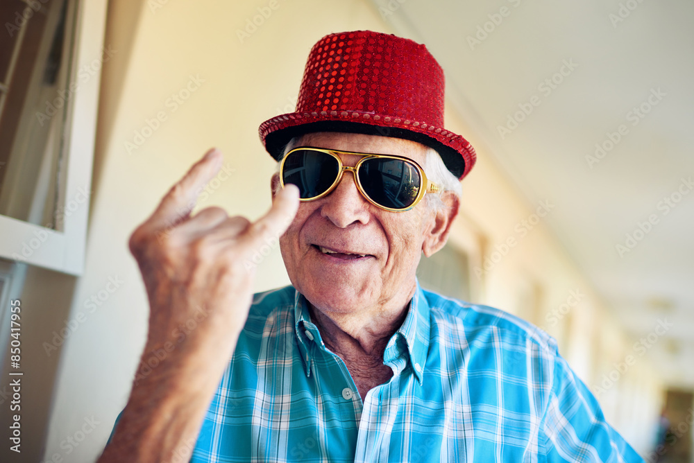 Rocker, smile and sunglasses with senior man in hallway of retirement home for goofy party on weekend. Portrait, funny and eyewear with happy mature person laughing at joke in elder care apartment Rocker, smile and sunglasses with senior man in hallway of retirement home for goofy party on weekend. Portrait, funny and eyewear with happy mature person laughing at joke in elder care apartment