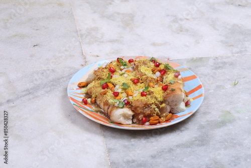 Gujarati Dish Bread Katka | Bread Dabeli In Dahi or Curd Garnished with Sev, Pomgranet, Masala Peanuts, Red & Green Chutney | Bread Chaat Indian & Pakistani Dish  photo