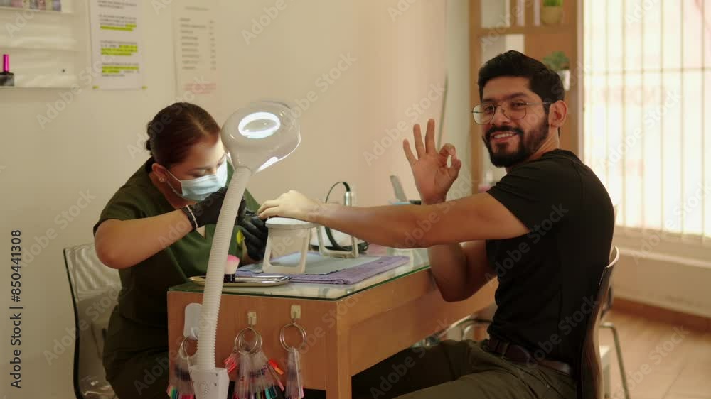 latin mexican handsome model beard say Ok good manicure session treatment procedure happy client efficiency happiness customer satisfaction spa wellness center