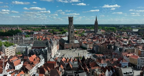 Belfry of Bruges, Belgium, June 2024. Drone orbit shot Bruges from above, with the famous Medieval belfry tower.