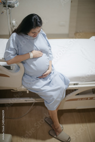 Pregnant Asian woman in a ward getting ready for labour