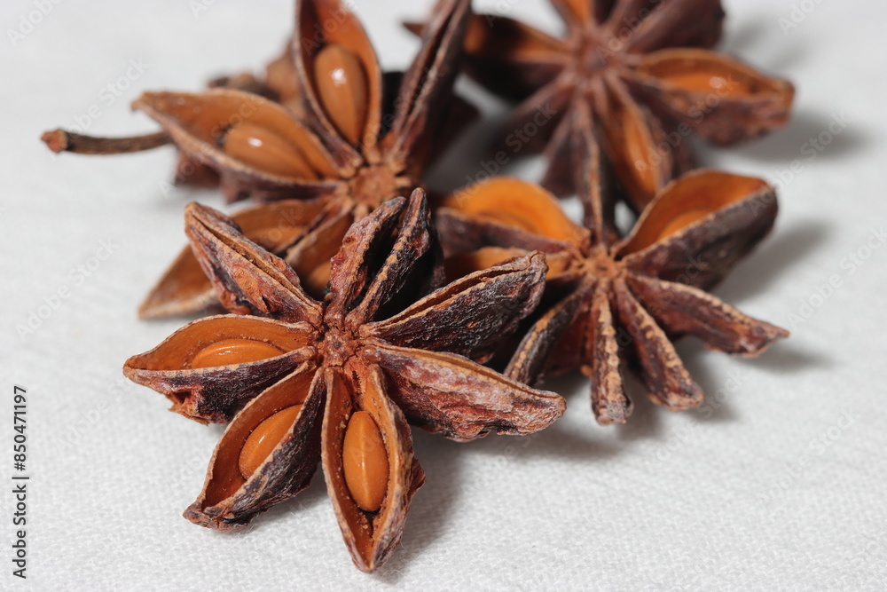 Star anise. Some star anise fruits with seed. Macro close-up on the jute burlap surface in rustic style. Star anise. Some star anise fruits with seed. Macro close-up on the jute burlap surface in rustic style.