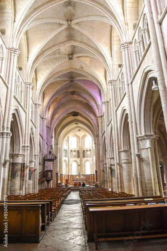 View of the center ale of an old churche with columns on each side in Auxonne France