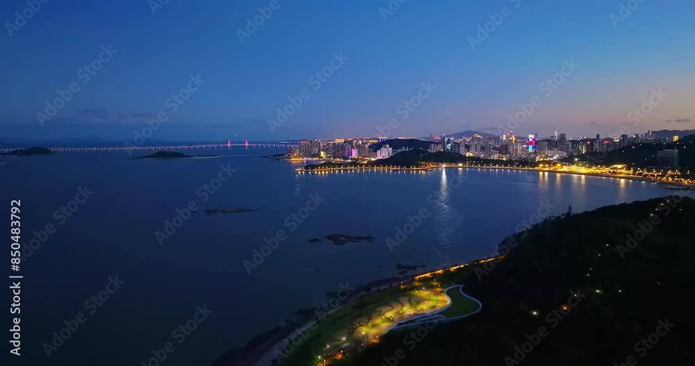 Aerial view of beautiful coastline with city skyline scenery at night in Zhuhai, Guangdong Province, China. Famous travel destination. Aerial view of beautiful coastline with city skyline scenery at night in Zhuhai, Guangdong Province, China. Famous travel destination.