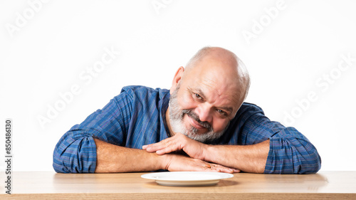 Concept showing Indian asian retired senior old man with empty ceramic plate, holding, presenting or pointing © StockImageFactory