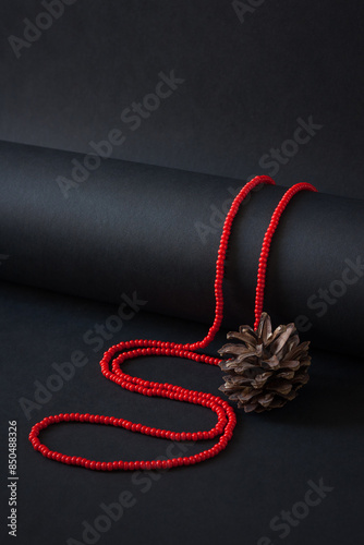 A necklace of red beads on a black background