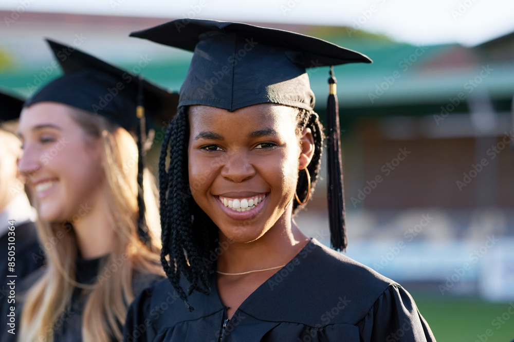 Happy black woman, student and education with class group at ceremony for graduation, qualification or future. Portrait of person and scholar with smile for diploma, certificate or degree on campus