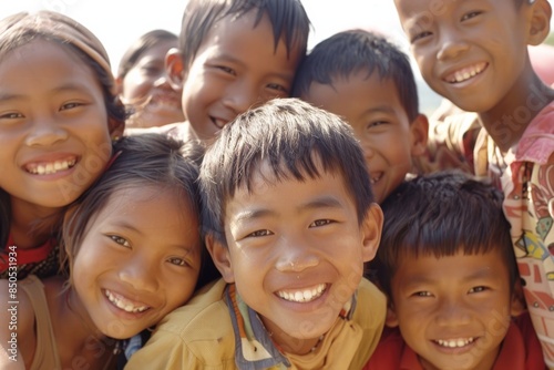 Group of children smiling in the park, close-up portrait. © Inigo