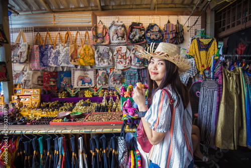 Woman travel in Bangkok city enjoy shopping in souvenir shop weekend market photo