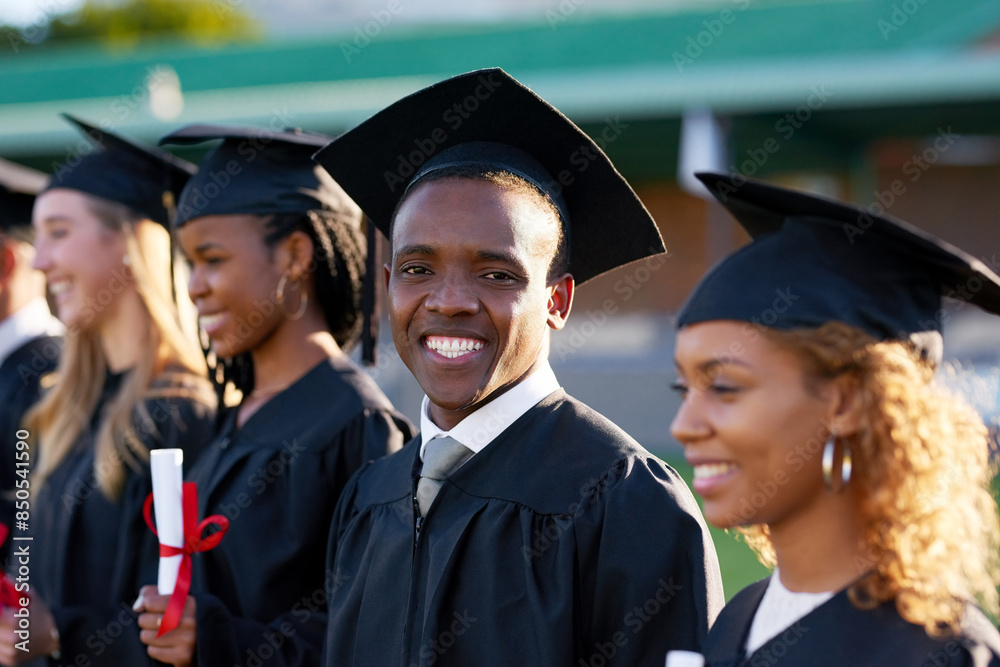 Happy black man, scholar portrait and graduation class with group at ceremony for education, qualification or future. Person and student with smile for diploma, certificate or degree on campus