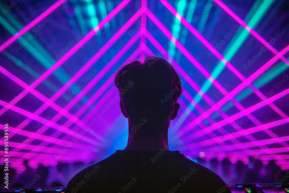 Silhouette of a man at a techno party with vibrant laser lights Silhouette of a man at a techno party with vibrant laser lights