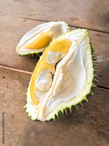 Fresh durain pulp on wooden table. Half of the durain fruit.