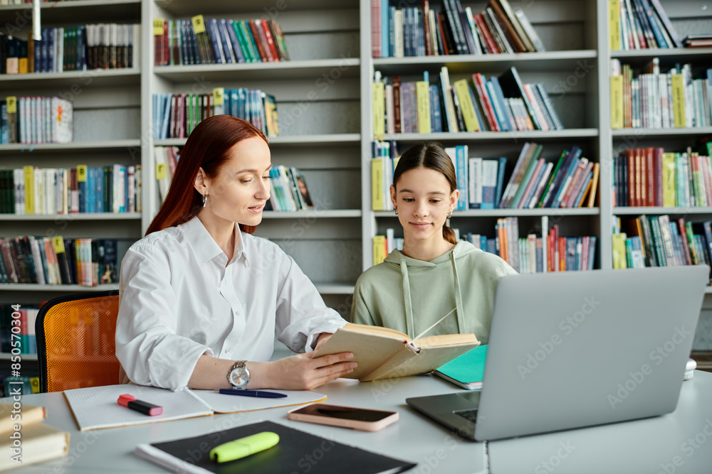 a tutor and a teenage student, engrossed in after-school lessons at a library table with a laptop. a tutor and a teenage student, engrossed in after-school lessons at a library table with a laptop.