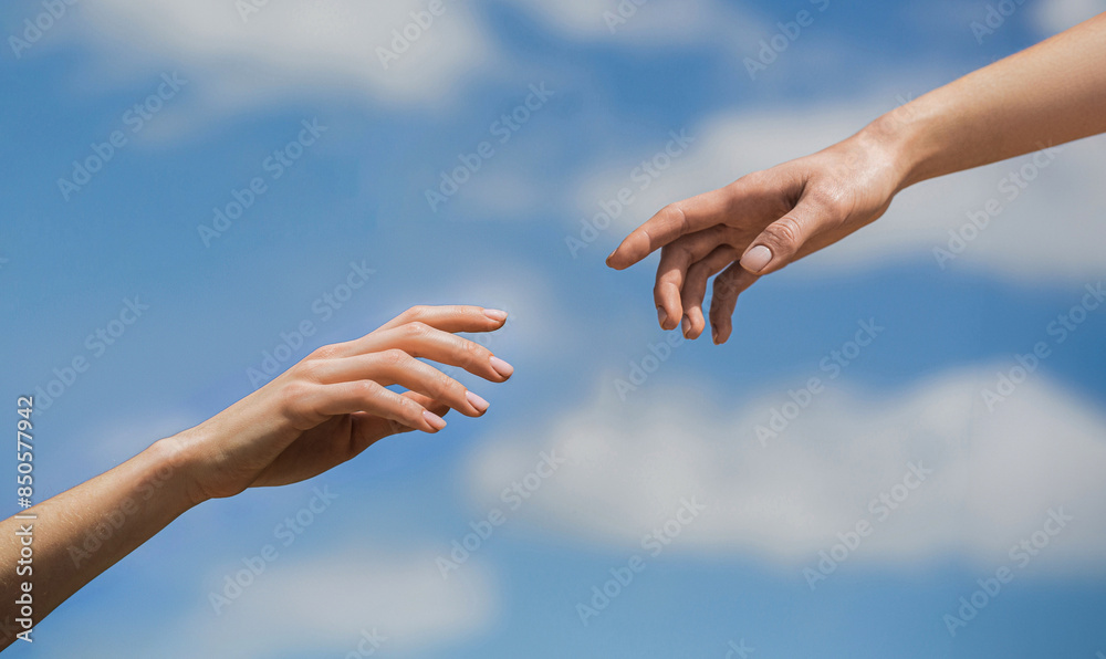 Two woman hands reaching towards each other on isolated sky background. Helping hand outstretched, salvation. Close up help hand. Two hands, helping arm friend, teamwork. Helping hand Two woman hands reaching towards each other on isolated sky background. Helping hand outstretched, salvation. Close up help hand. Two hands, helping arm friend, teamwork. Helping hand