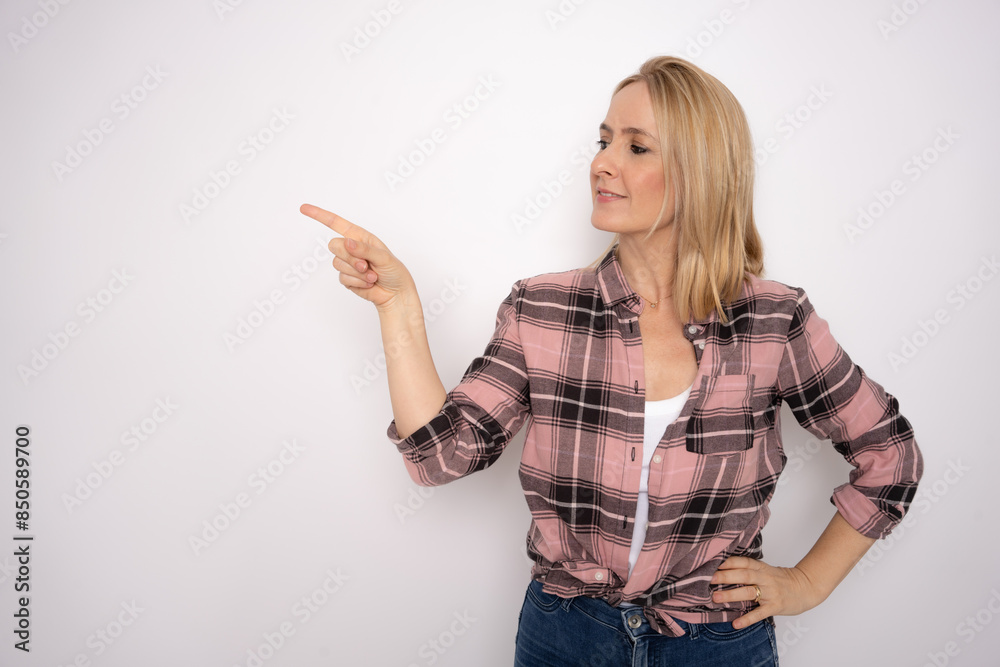 Young woman pointing fingers to the side over isolated white background Young woman pointing fingers to the side over isolated white background