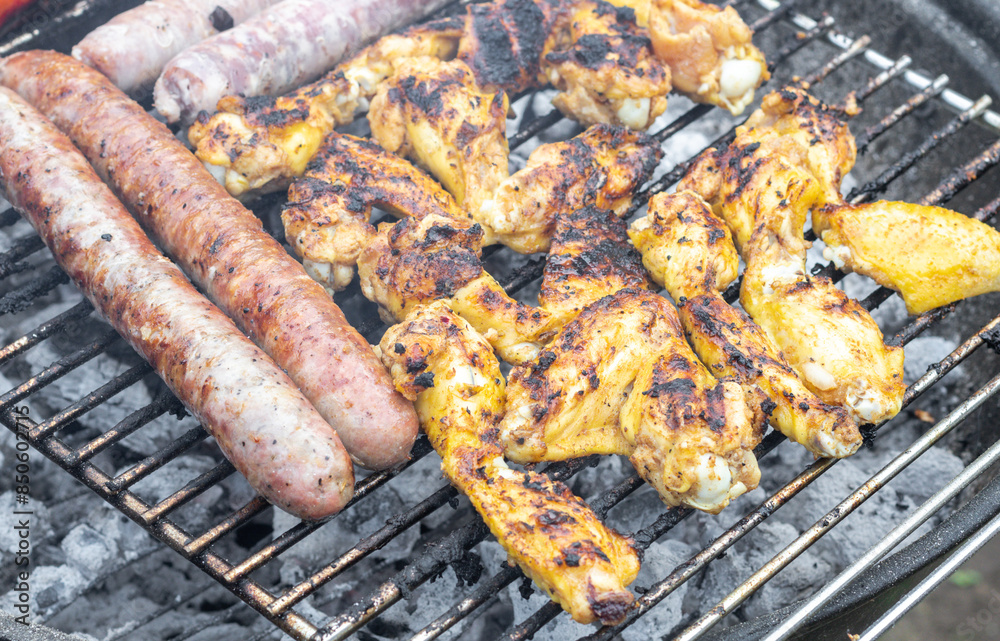 Fried sausages and grilled chicken wings. Fried sausages and grilled chicken wings.