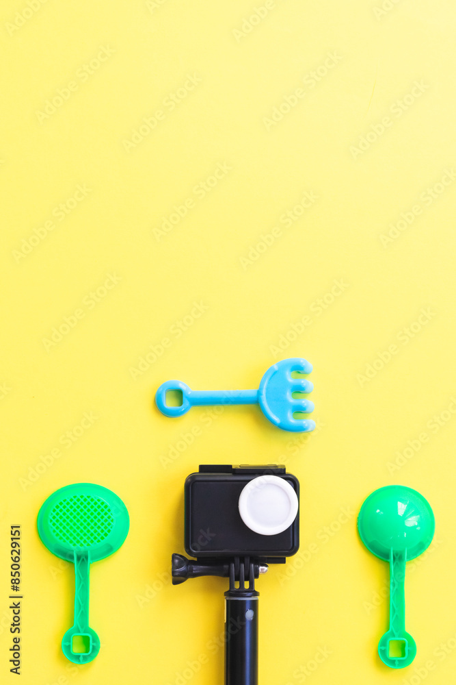 One camera and children set for sand on a yellow background. One camera and children set for sand on a yellow background.