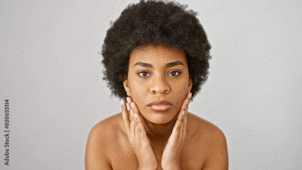 African american woman with curly hair poses on a white isolated background, conveying beauty and confidence. African american woman with curly hair poses on a white isolated background, conveying beauty and confidence.