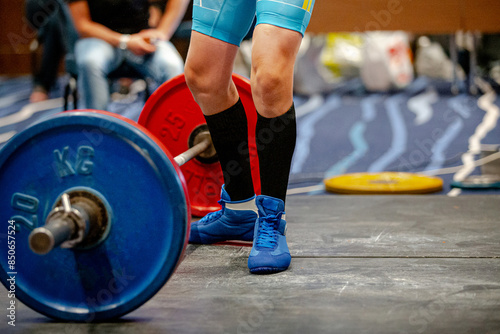 legs woman athlete in black knee socks near barbell deadlift