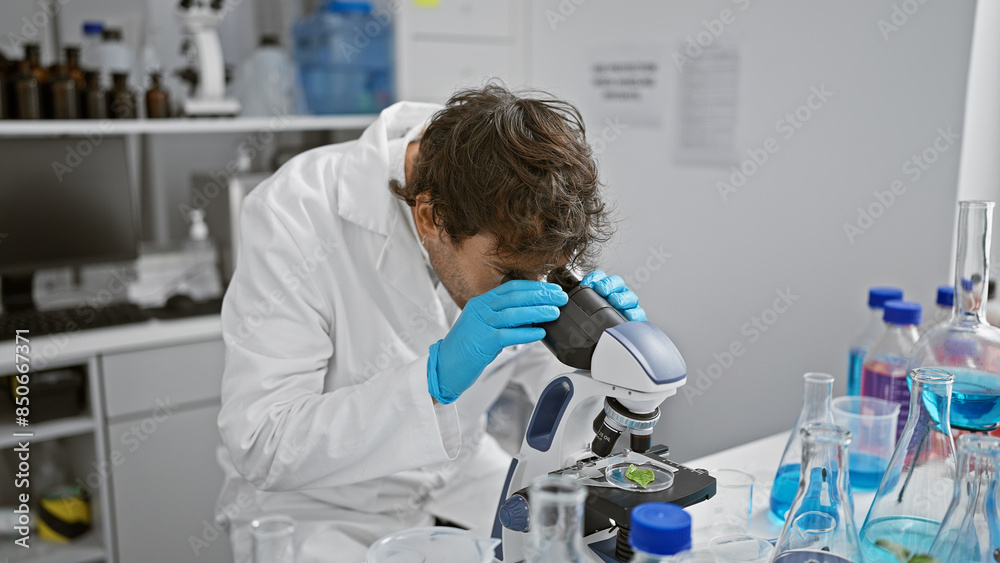 Focused scientist examining samples on a microscope in a laboratory setting, surrounded by glassware and equipment. Focused scientist examining samples on a microscope in a laboratory setting, surrounded by glassware and equipment.