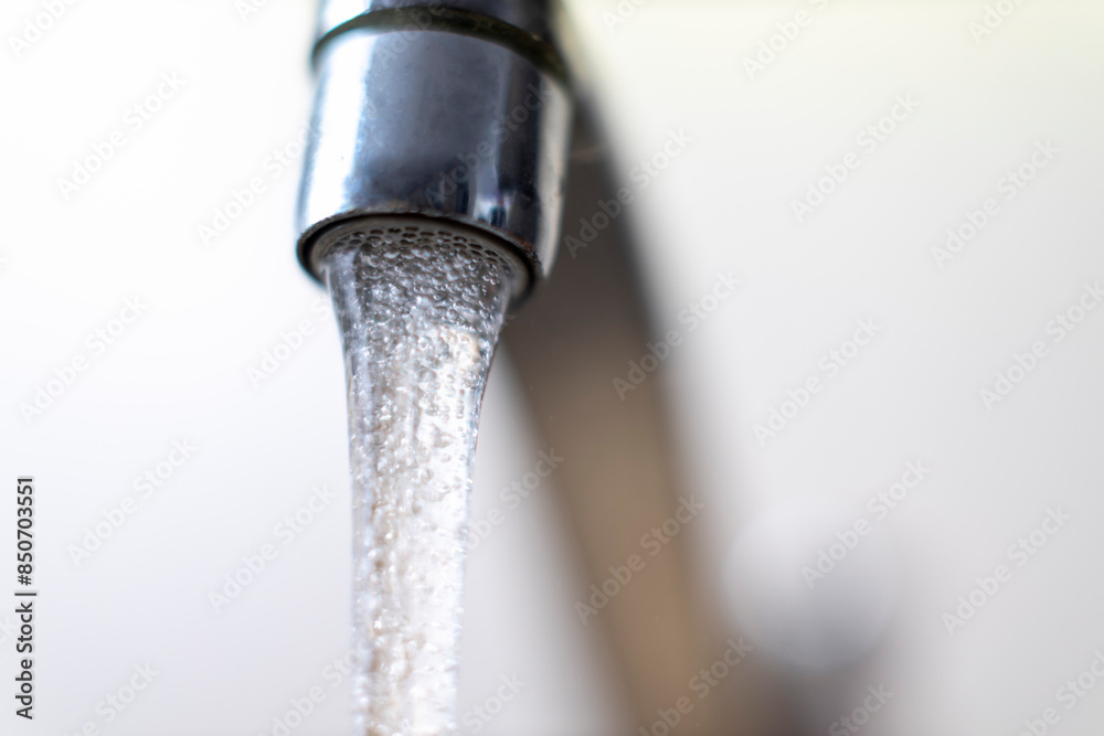 Running water from kitchens faucet - shallow focus. Running water from kitchens faucet - shallow focus.