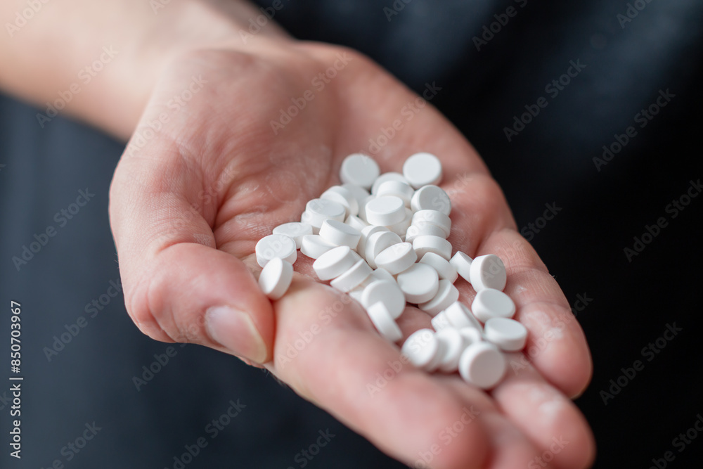 Placebo pills holding in a hand - close up view Placebo pills holding in a hand - close up view
